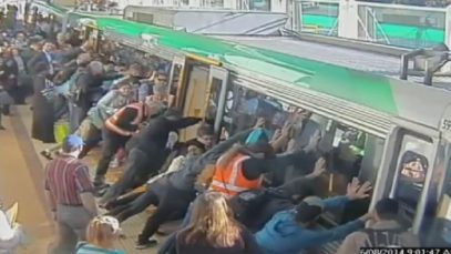 Mind the gap: Commuters push train to save trapped man